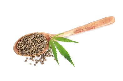 Photo of Wooden spoon with hemp seeds and leaf on white background, top view