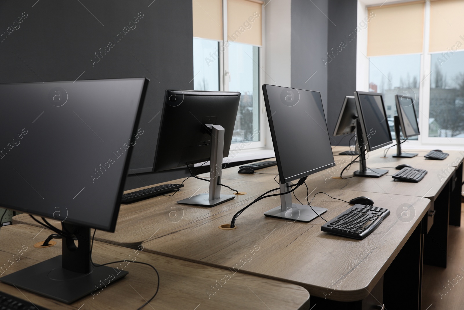 Photo of Many modern computers in open space office