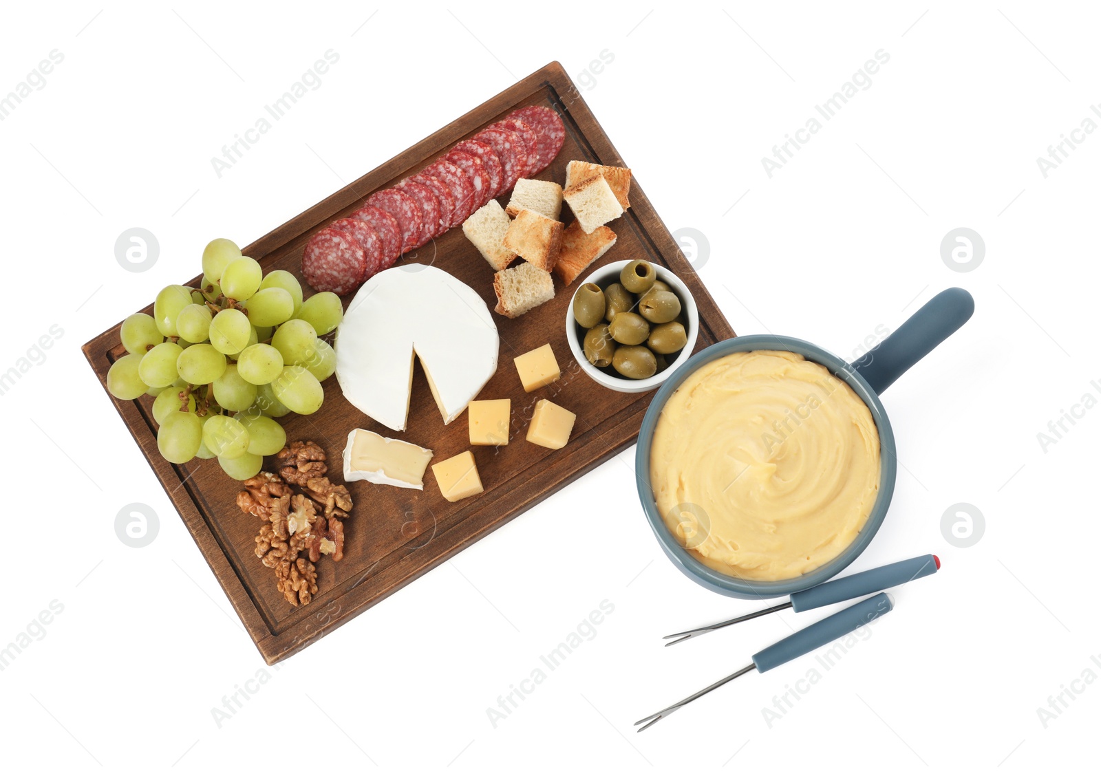 Photo of Fondue with tasty melted cheese, forks and different snacks isolated on white, top view