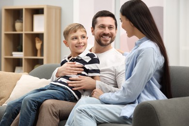 Photo of Pregnant woman spending time with her son and husband at home