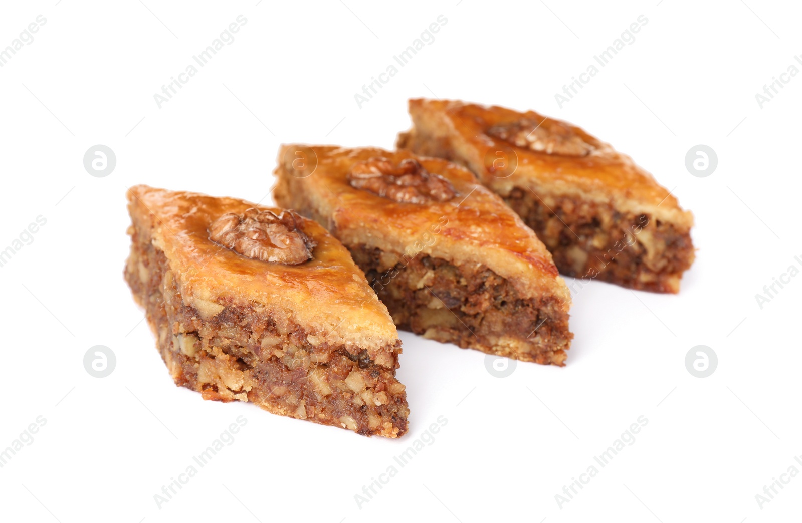 Photo of Delicious honey baklava with walnuts on white background