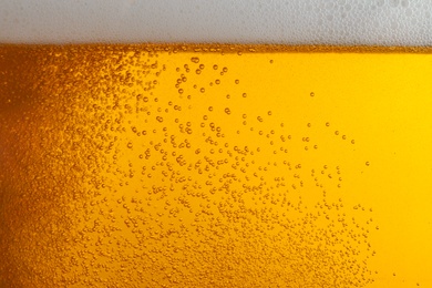 Glass of tasty beer with foam, closeup