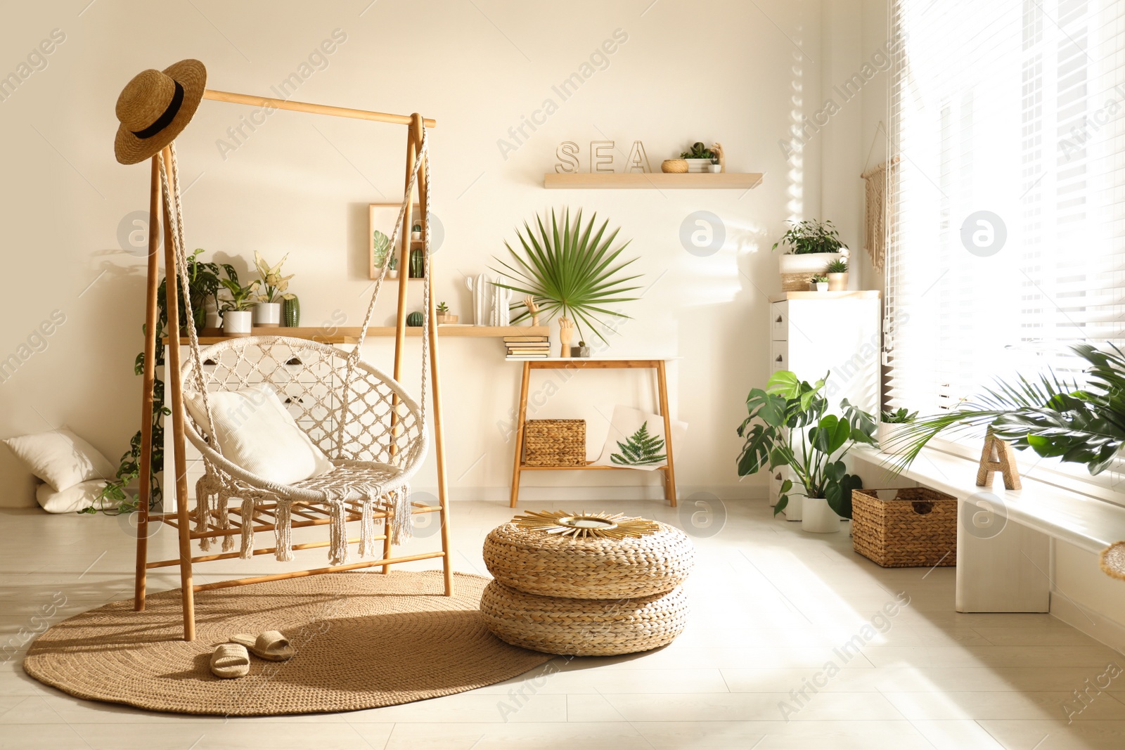 Photo of Comfortable hammock chair in stylish room. Interior design