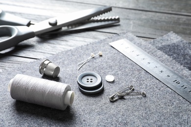 Set of tailoring accessories and fabric on table