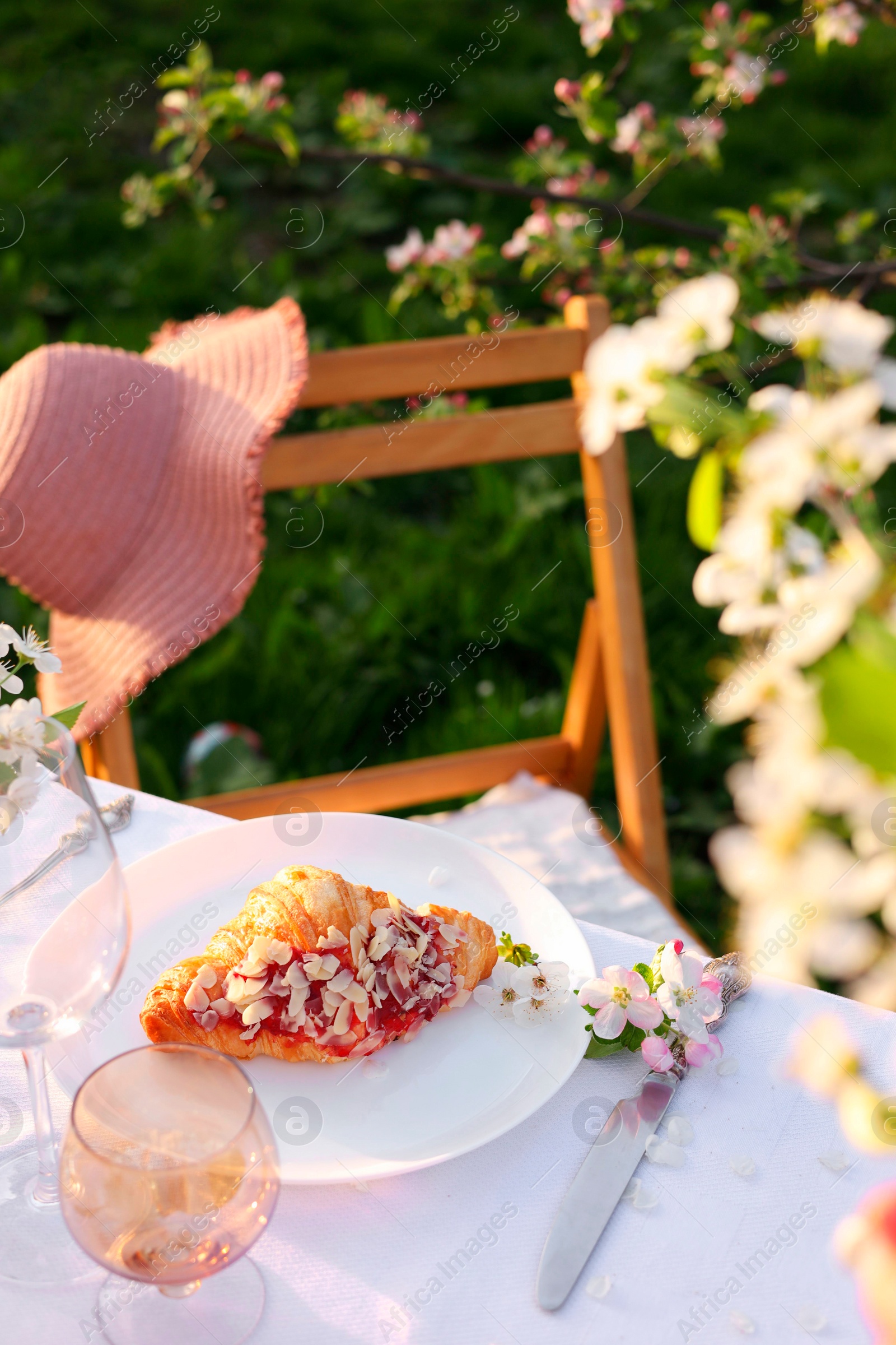 Photo of Stylish table setting with beautiful spring flowers in garden