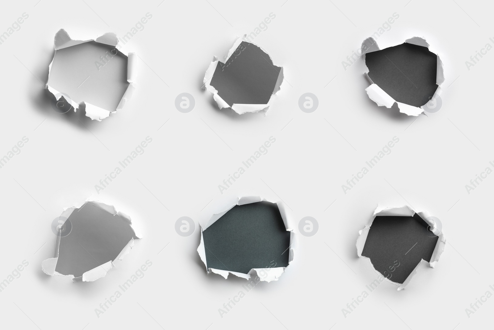 Image of White paper with different holes on color background