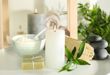 Photo of Beautiful spa composition with candles and cosmetic on white table