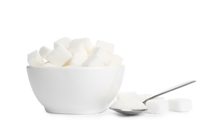 Photo of Ceramic bowl and spoon with refined sugar cubes on white background