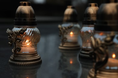 Photo of Grave lights on granite surface at cemetery