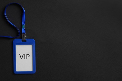 Photo of Plastic vip badge on black background, top view. Space for text