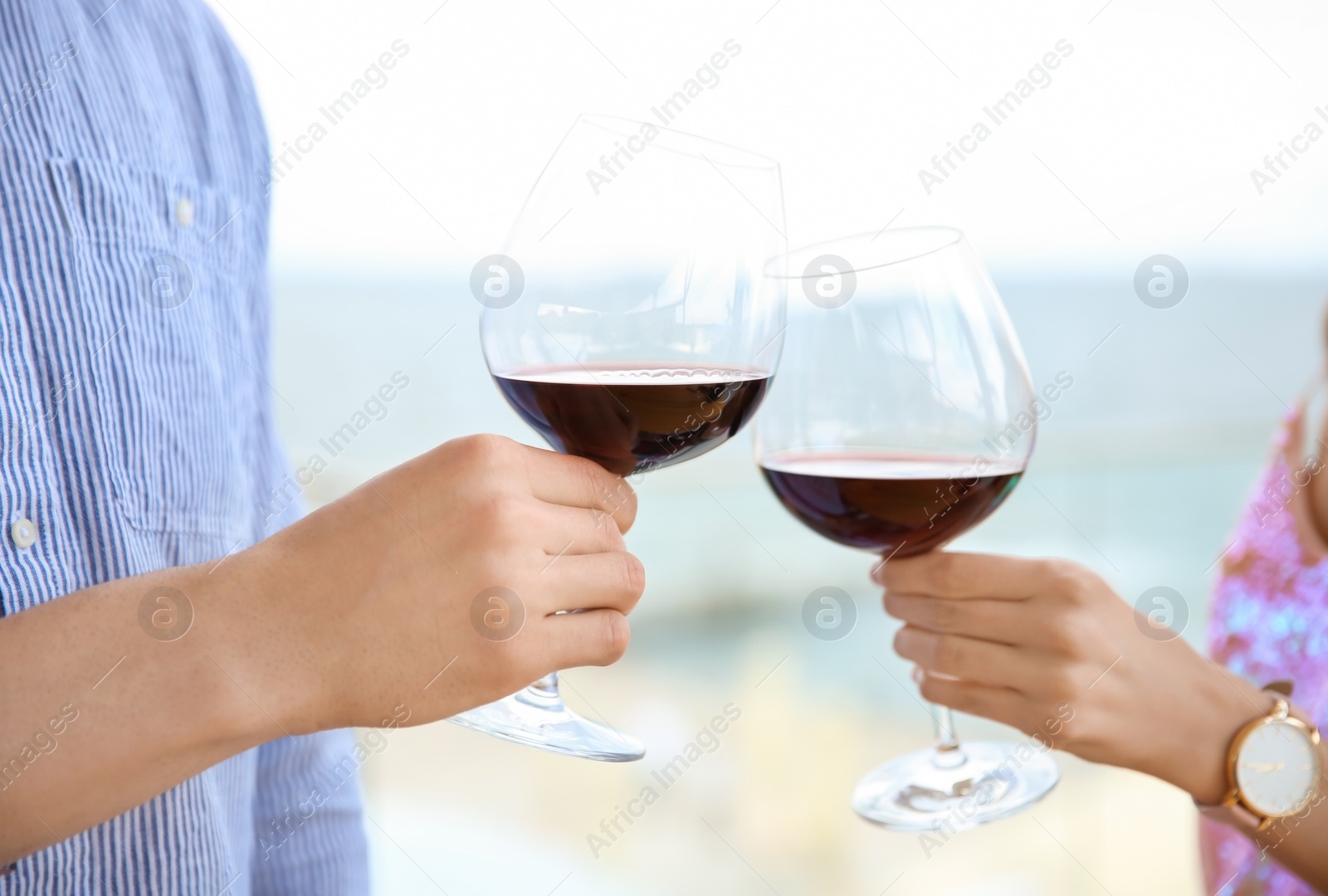 Photo of Young romantic couple with glasses of red wine outdoors