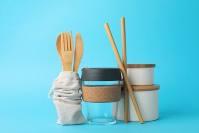 Photo of Composition with eco friendly products on light blue background. Conscious consumption