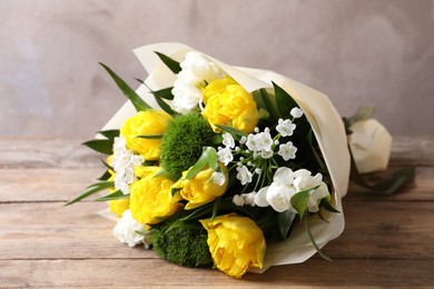 Photo of Beautiful bouquet with peony tulips on wooden table