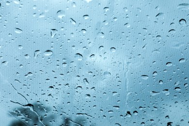 Photo of Window glass with water drops, closeup view