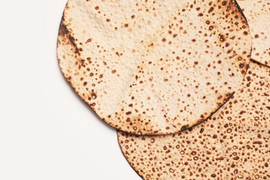 Photo of Tasty matzos on white background, top view. Passover (Pesach) celebration