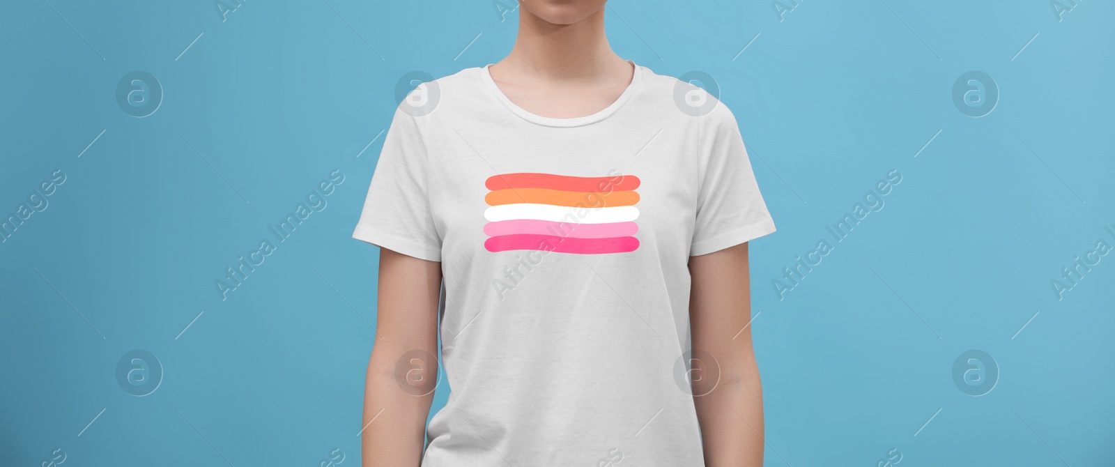 Image of Young woman wearing white t-shirt with lesbian flag on light blue background, banner design. LGBT concept