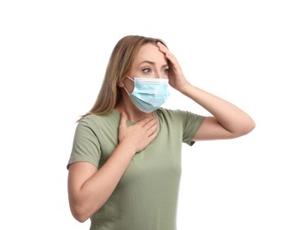 Photo of Young woman in medical mask suffering from pain during breathing on white background