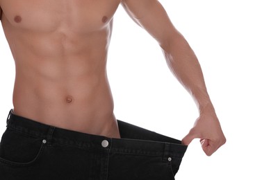 Photo of Shirtless man with slim body wearing big jeans isolated on white, closeup