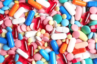 Many colorful pills as background