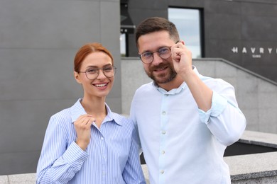 Portrait of happy couple in glasses outdoors