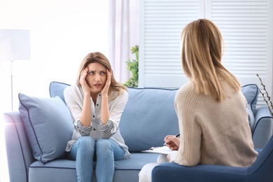 Female psychologist with client in office