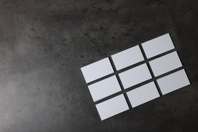 Photo of Blank business cards on grey textured background, top view. Mockup for design