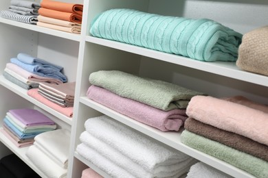 Different color linens on shelves in shop