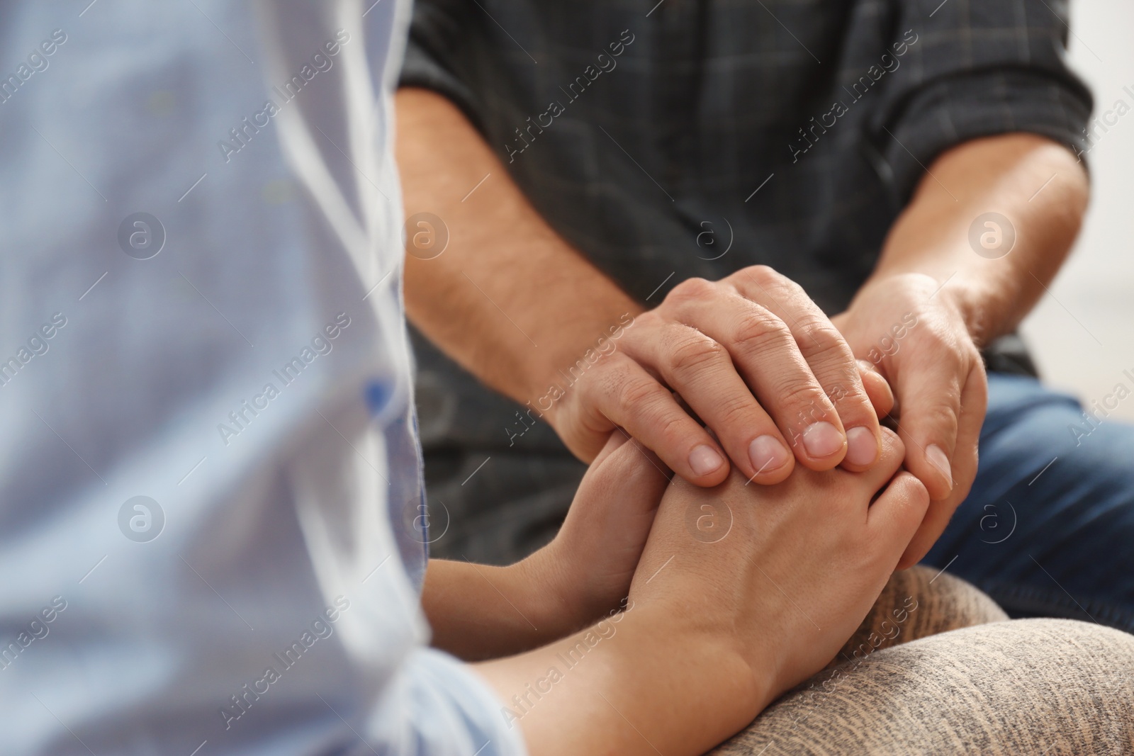 Photo of Man comforting woman, closeup of hands. Help and support concept