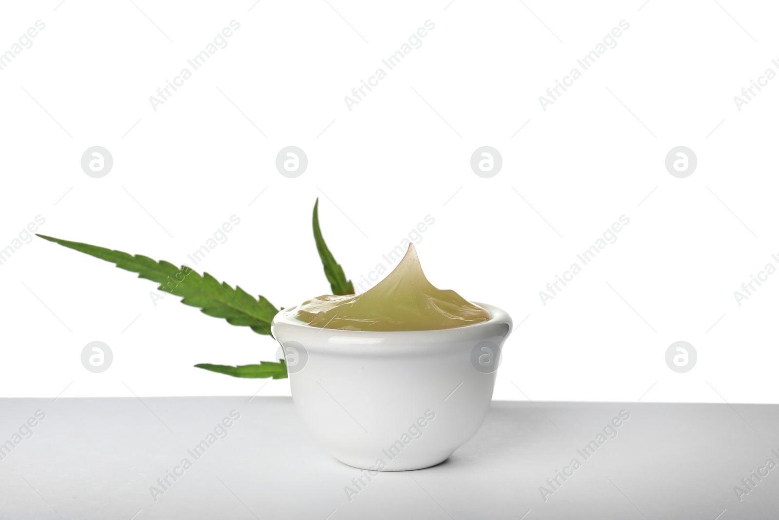 Photo of Bowl with hemp lotion on white background