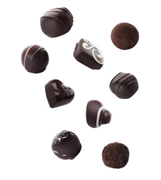 Falling different chocolate candies on white background