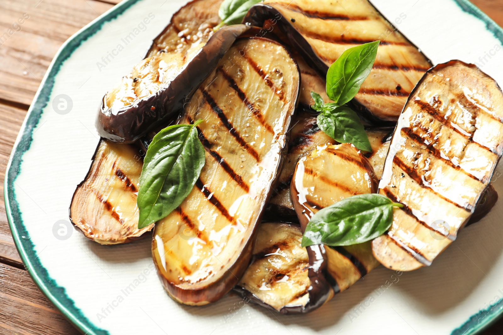 Photo of Plate with tasty fried eggplant slices, closeup