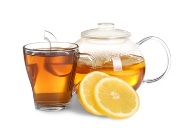 Photo of Cup and teapot with lemon tea on white background