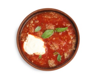 Photo of Bowl of delicious stuffed pepper soup on white background, top view