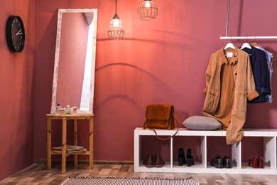 Modern hallway interior with hanging clothes and shoe rack