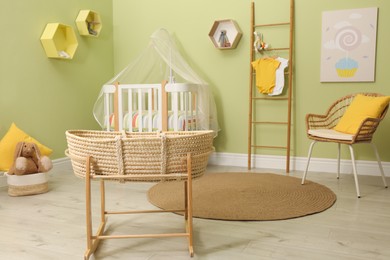 Photo of Baby room interior with stylish furniture and wicker cradle