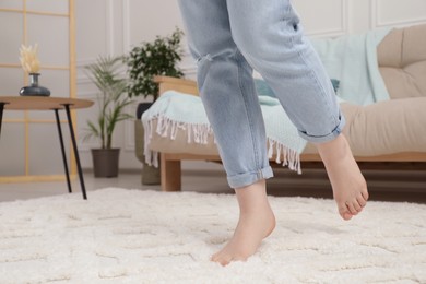 Photo of Woman standing on beige carpet in room, closeup. Space for text