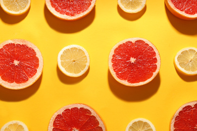 Photo of Flat lay composition with tasty ripe grapefruit slices on yellow background