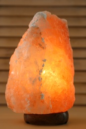 Photo of Himalayan salt lamp on wooden table