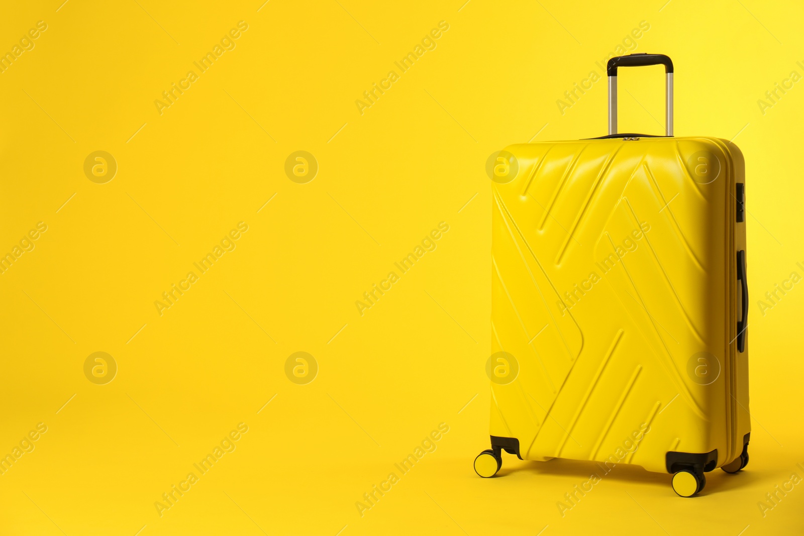 Photo of Stylish suitcase on color background. Space for text