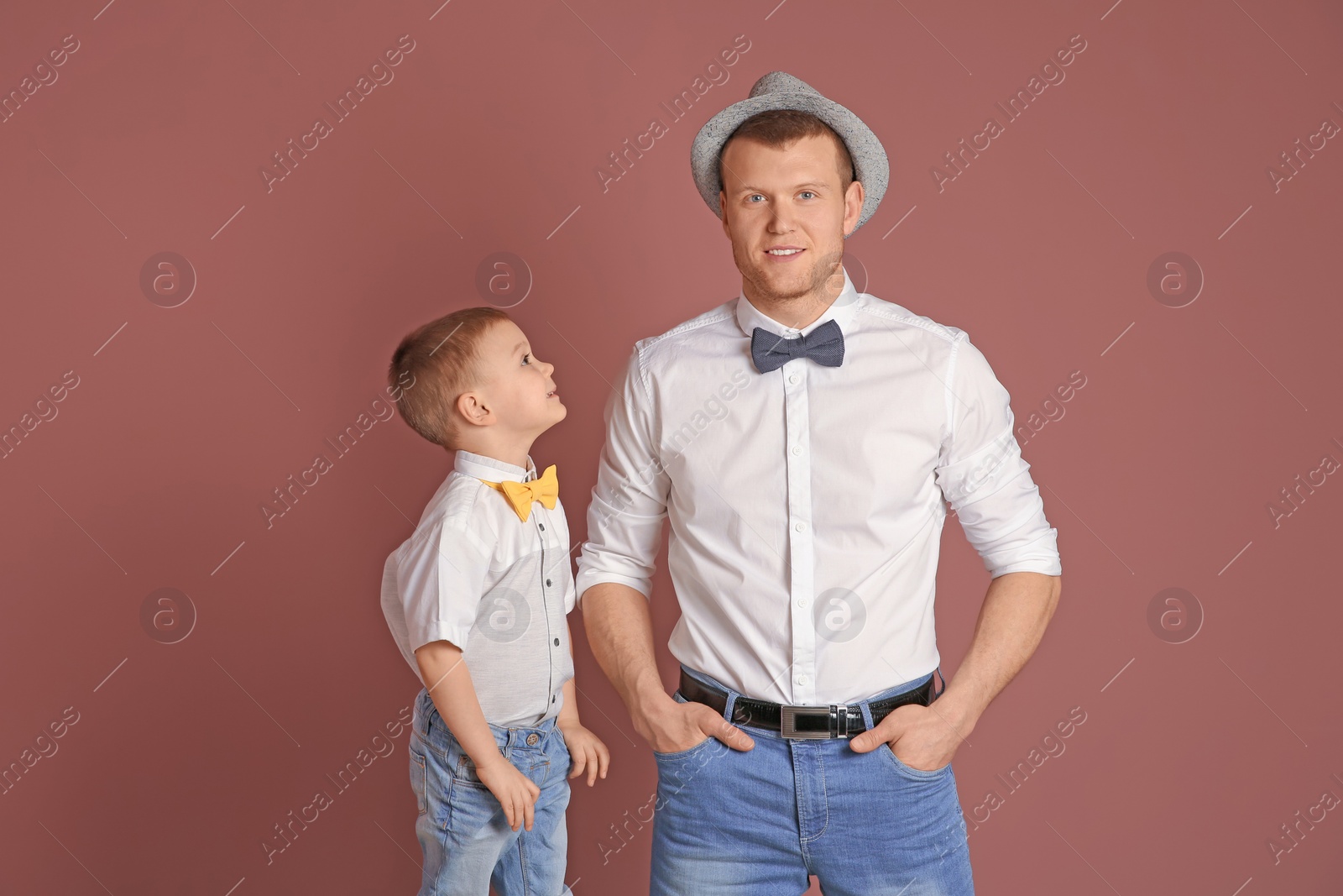 Photo of Dad and his son on color background. Father's day celebration