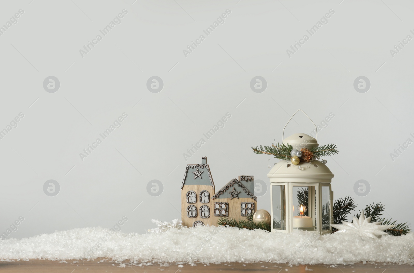 Photo of Beautiful composition with vintage Christmas lantern and festive decorations on snow against white background. Space for text