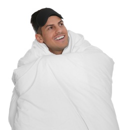 Photo of Man in sleeping mask wrapped with blanket on white background