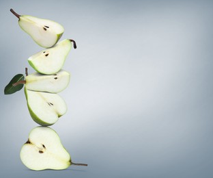 Image of Cut fresh ripe pears on grey gradient background, space for text