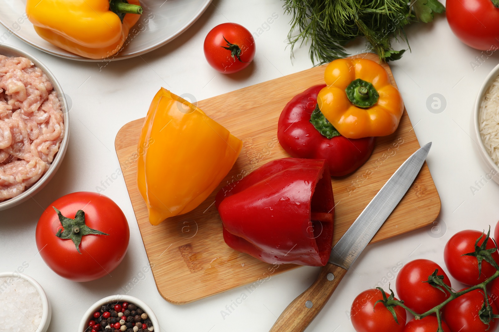 Photo of Making stuffed peppers. Vegetables and ground meat on white marble table, flat lay