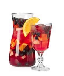 Photo of Glass and jug of Red Sangria isolated on white