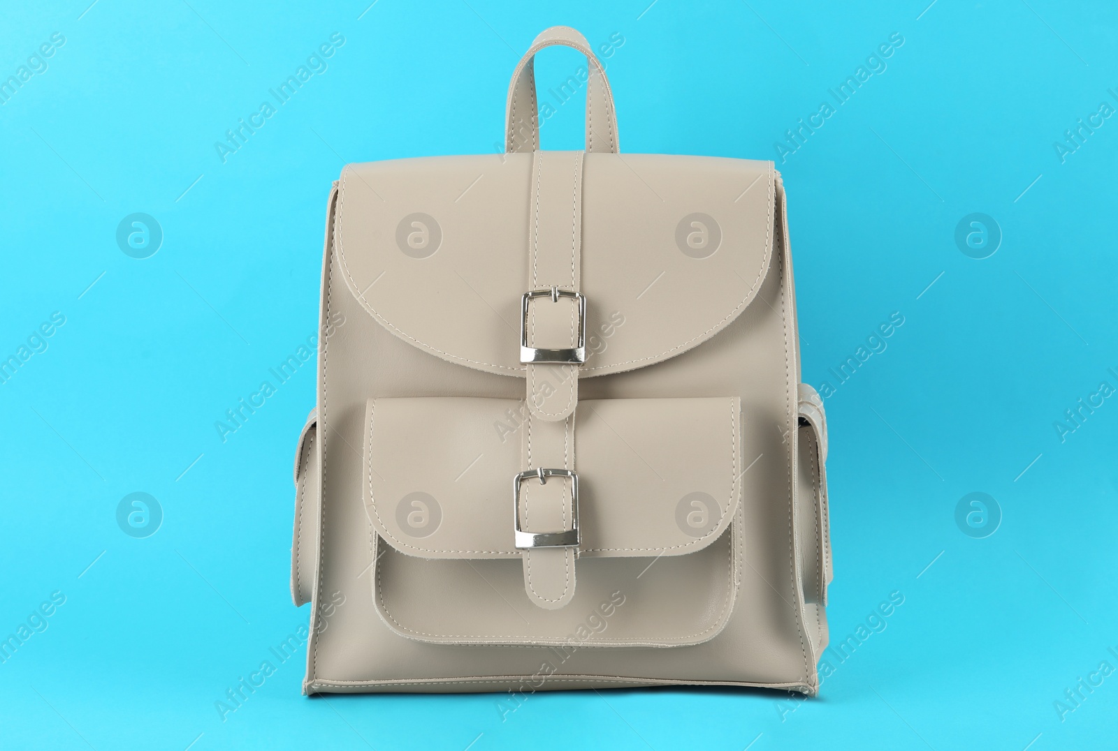 Photo of Stylish urban backpack on light blue background