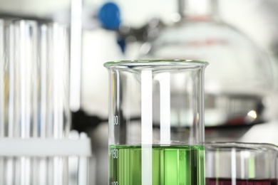 Image of Glass beaker with liquid sample, closeup. Laboratory analysis