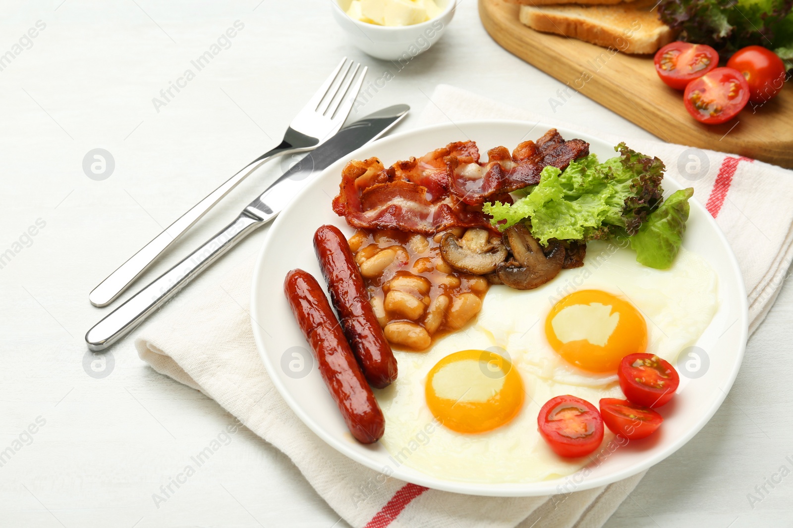 Photo of Delicious breakfast with sunny side up eggs served on white table, closeup