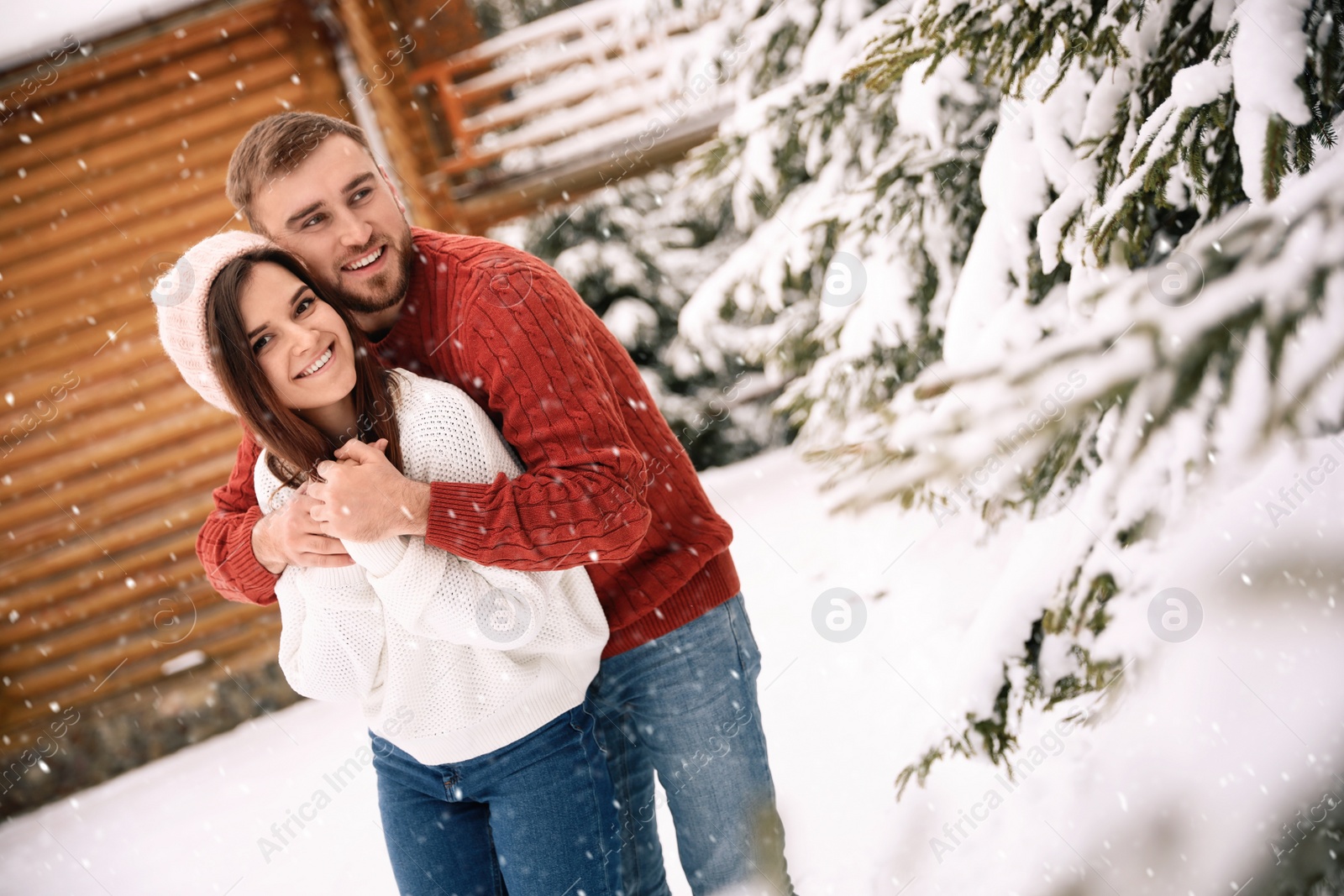 Photo of Lovely couple spending time together on snowy day. Winter vacation