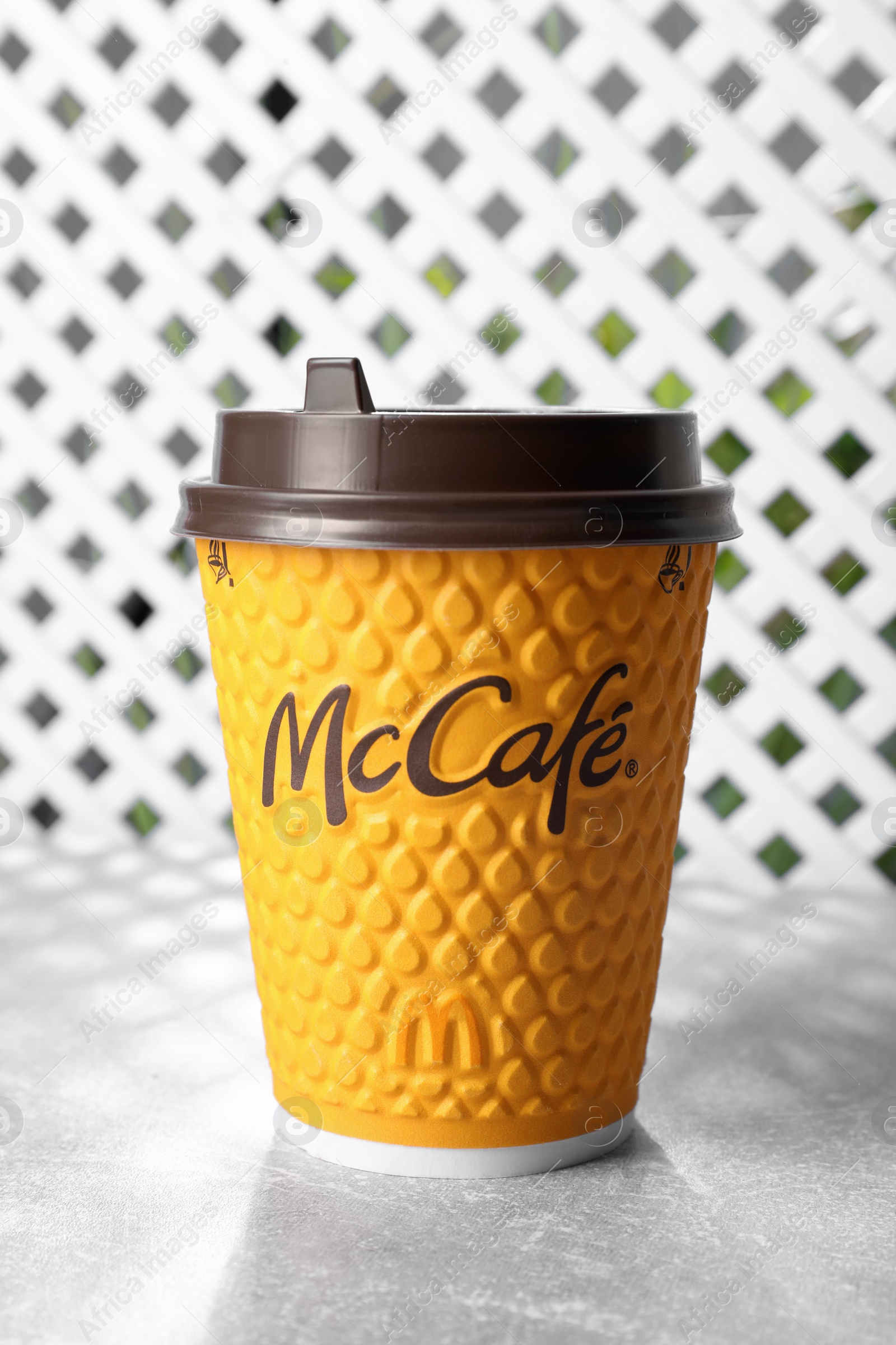 Photo of MYKOLAIV, UKRAINE - AUGUST 12, 2021: Hot McDonald's drink on grey table